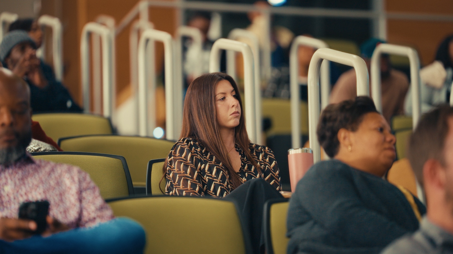 Audience gathered in a lecture hall during a filmed event