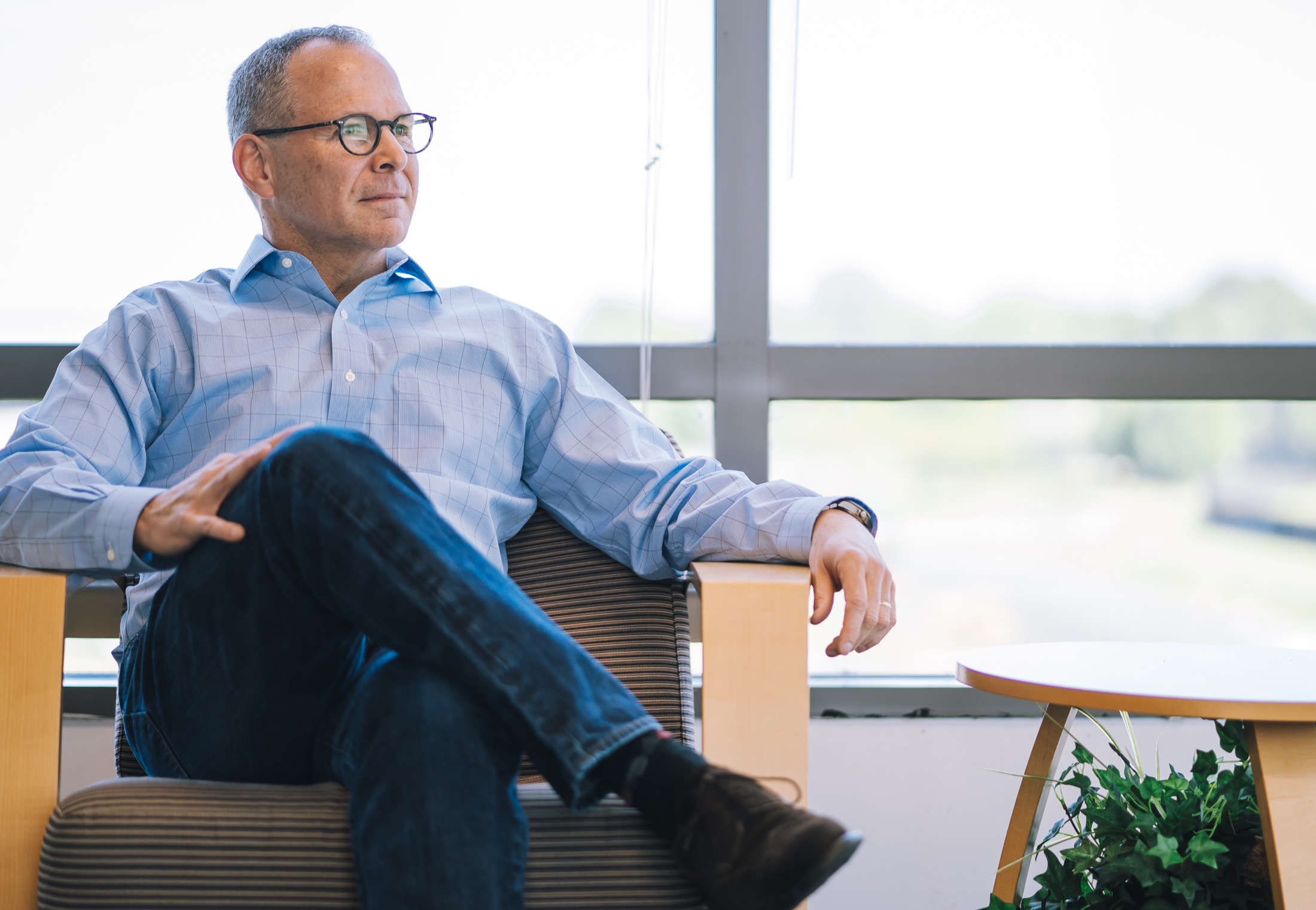 Professional seated in a bright office for an executive portrait