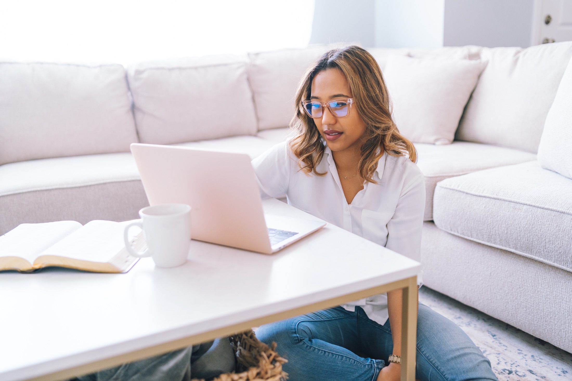 Professional working on a laptop in a bright home setting