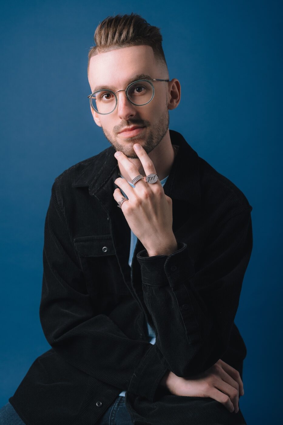Creative studio portrait on a blue background