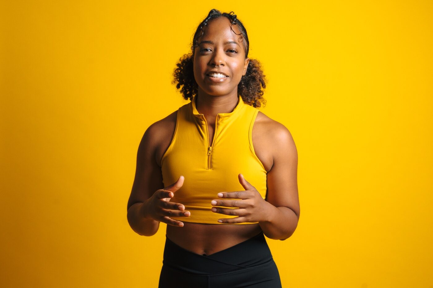 Fitness brand portrait on a yellow studio background