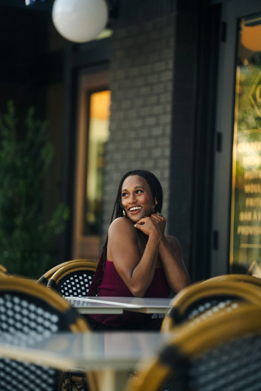 Jasmine Neely laughing at an outdoor café table