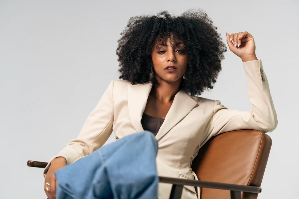 Morgan Miller seated in a cream blazer for a personal-brand portrait