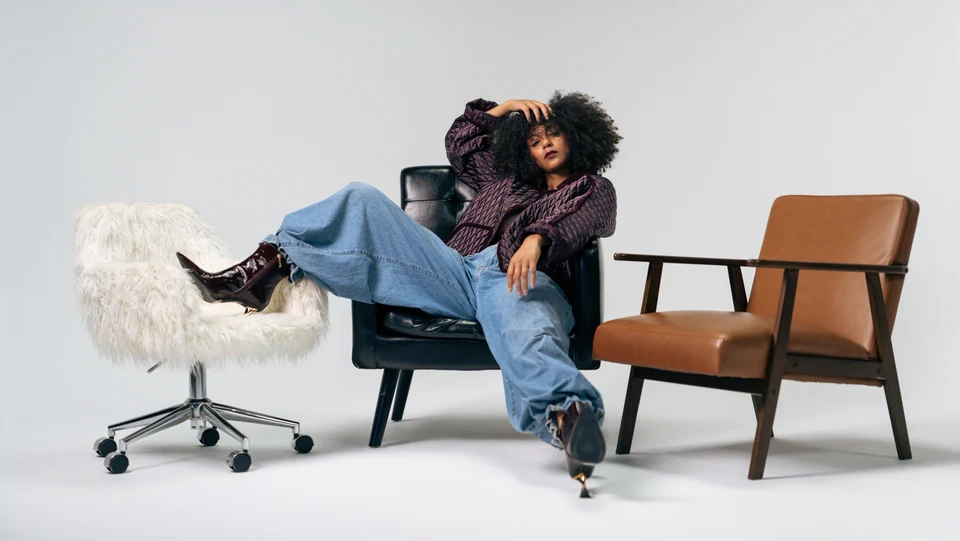 Morgan Miller reclining in a wide editorial studio portrait